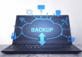 Data Backup and Recovery Image featuring a cloud on a laptop